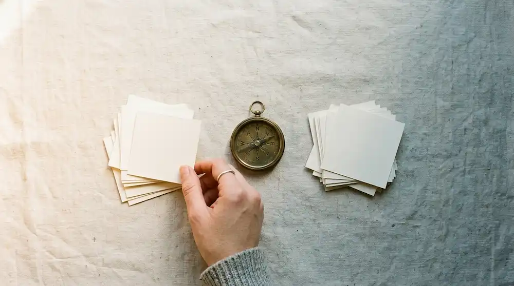 A hand sorting options into two piles guided by a compass, representing scoring career choices against core values.